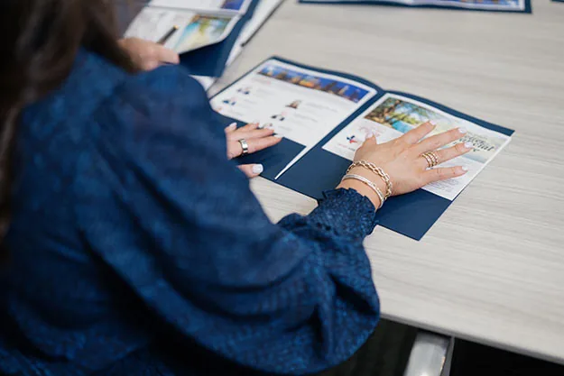 Woman reviewing financial planning materials during a Winstone Wealth Partners client consultation in Houston, TX